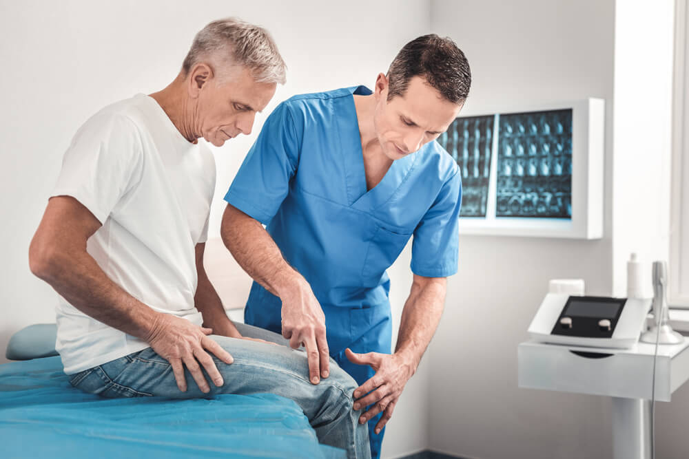 Doctor Examining Patient's Knee